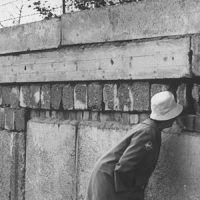 Woman looking through a hole in the Berlin Wall.  (Photo by Robert Lackenbach//Time Life Pictures/Getty Images)