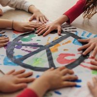 Schoolchildren making poster of peace sign at school.; Shutterstock ID 2137605687; purchase_order: RI29; job: rivista la ricerca; client: emazzucchetti; other: